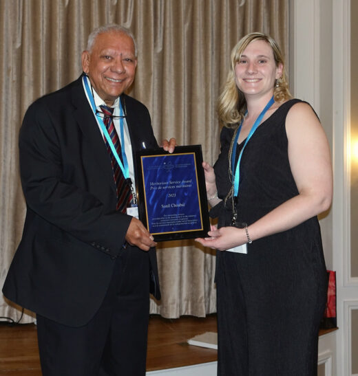 Leah Shuparski-Miller presenting the Meritorious Service Award to award to Sunil Choubal.